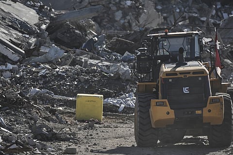 A yellow block demarcating the "Yellow Line," which has separated the Gaza Strip's Israeli-held and Palestinian zones since the October ceasefire, is visible in Jabalia, northern Gaza Strip. where Hamas militants are searching for the remains of hostages, Monday, Dec. 1, 2025.