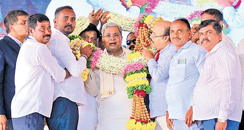 Congress leaders welcome Chief Minister Siddaramaiah during the foundation stone laying ceremony for development works at Varuna constituency on Sunday.