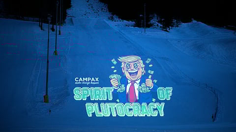 A projection by Campax depicting US president Donald Trump and reading "spirit of plutocracy" is projected on a ski slope prior to the 56th annual meeting of the World Economic Forum in Davos, Switzerland, Monday, Jan. 19, 2026.
