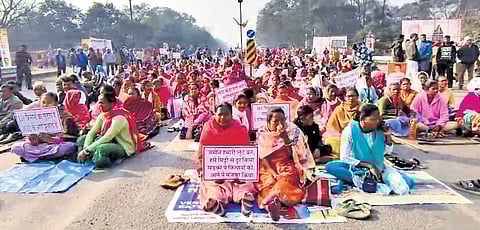 Agitators staging protest on Biju Expressway Jhagarpur on Monday