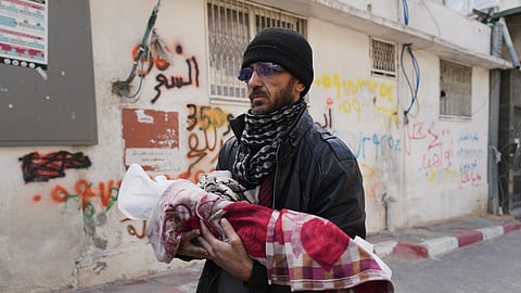 Khalid Abu Jarad holds the body of his 3-month-old niece, Shaza Abu Jarad, who, according to the health ministry, died from hypothermia, in Gaza City, Tuesday, Jan. 20, 2026.
