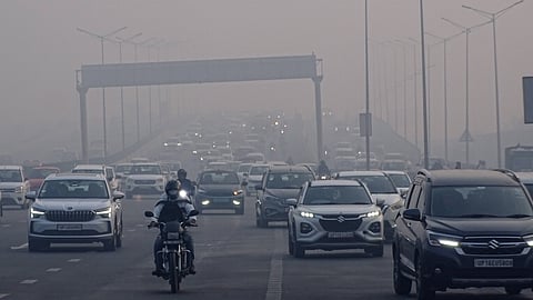 Commuters make their way during a cold and foggy winter morning.