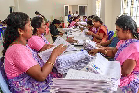 Electoral staff segregate forms of the special intensive revision (SIR) of electoral rolls, in Tirunelveli, Tamil Nadu