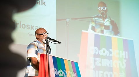 In this image from January 26, 2026, artist Bose Krishnamachari is seen speaking at the Soil Assembly conference held at the Kochi Muziris Biennale.
