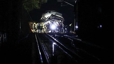 Firefighters and rescue personnel work at the site where at least one person died and four were seriously injured when a regional service train collided with a collapsed wall between Sant Sadurni d'Anoia and Gelida, near Barcelona, early January 21, 2026.