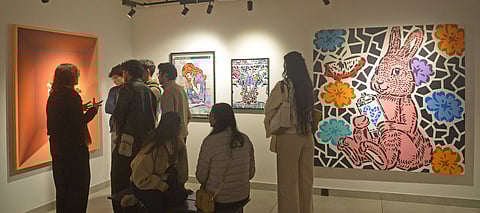 An art tour guide at a Defence Colony gallery during the Defence Colony Gallery hop