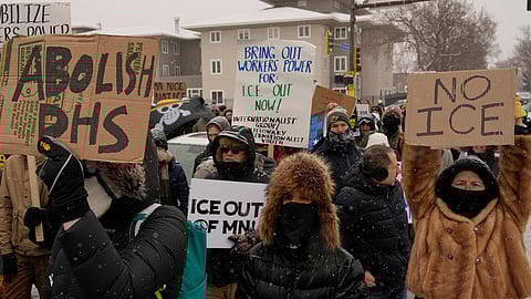 People gather near the post office during a protest on Sunday, Jan. 18, 2026, in Minneapolis.