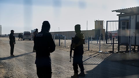 Syrian government troops stand guard at the entrance to the al-Hol camp in northeastern Syria's Hasakeh province, Syria, Wednesday, Jan. 21, 2026, after the withdrawal of the Syrian Democratic Forces (SDF).