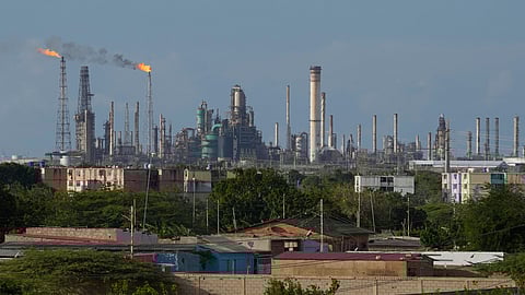 Flames rise from flare stacks at the Amuay refinery in Los Taques, Venezuela, Wednesday, Jan. 14, 2026.