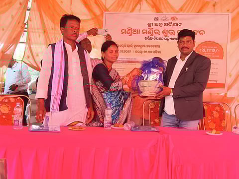 A self help group member is presenting ragi to Chitrakonda MLA Mangu Khilla during the opening of ragi procurement centre at Nuaguda village in Mathili block