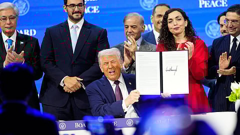 President Donald Trump holds the charter during a signing ceremony on his Board of Peace initiative at the Annual Meeting of the World Economic Forum in Davos, Switzerland, Thursday, Jan. 22, 2026.