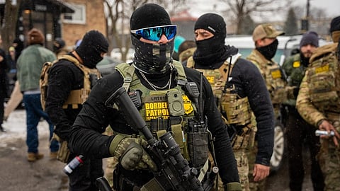 Federal agents stand guard, Wednesday, Jan. 21, 2026, in Minneapolis.