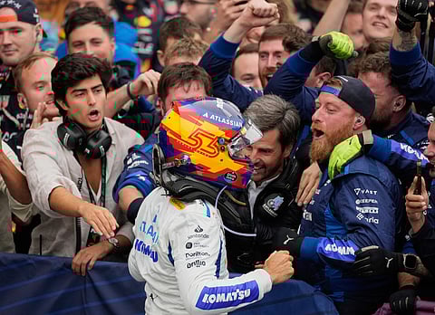 Williams driver Carlos Sainz of Spain celebrates third place with his team.