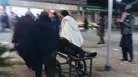 Volunteers transport an injured victim of suicide bombing at a wedding, Friday, Jan. 23, 2026, at a hospital in Dera Ismail Khan, Pakistan.