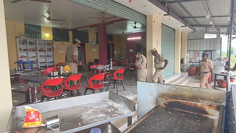 Senior police officials inspect the site near Thirumandurai Toll Plaza in Perambalur district after a daylight bomb attack on a history-sheeter being escorted to prison, Saturday, Jan. 24, 2026.