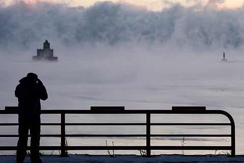 Doug Kunde watches as steam is seen over Lake Michigan as frigid temperatures for the day are not expected to reach zero degrees Friday, Jan. 23, 2026, in Milwaukee.
