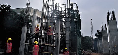 Labourers busy working at the Chennai Metro Rail Limited construction site in
St Thomas Mount under a blanket of dark clouds on Friday.