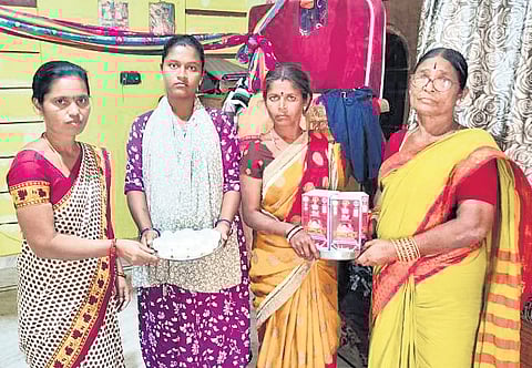 ICDS officials hand over milk and eggs to Ubidi Rekha at her residence before she was shifted to a hospital on Saturday.