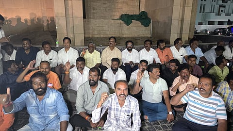 BJP workers staged a protest condemning the fire incident at the Reddy model house on Friday in Ballari.