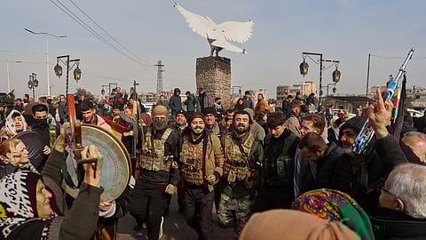 Kurdish fighters with the Syrian Democratic Forces (SDF) are cheered by local residents ahead of the end of a four-day truce with the Syrian government in Hassakeh, northeastern Syria, Saturday, Jan. 24, 2026.