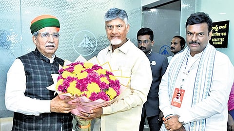 Chief Minister N Chandrababu Naidu greets Union Minister for Law Arjun Ram Meghwal at the Gannavaram airport as BJP AP chief PVN Madhav looks on.