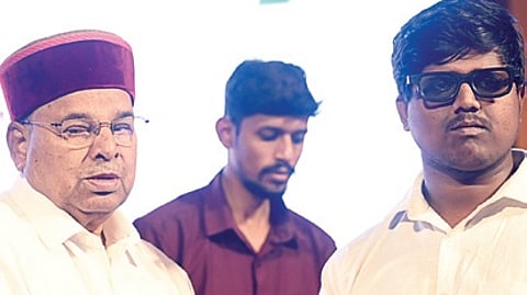 Governor Thaawarchand Gehlot hands out voter ID to a physically challenged youth on National Voters’ Day in Bengaluru on Sunday