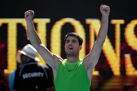 Carlos Alcaraz of Spain celebrates after defeating Tommy Paul of the U.S. in their fourth round match at the Australian Open tennis championship in Melbourne, Australia, Sunday, Jan. 25, 2026.