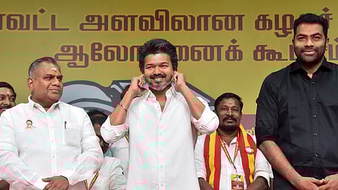 TVK Chief Vijay, centre, gestures during a state and district-level Executive Cadre Consultation Meeting at Mamallapuram