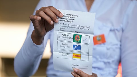 An official of the Union Election Commission counts ballots at a polling station during the final round of the general election Sunday, Jan. 25, 2026, in Yangon, Myanmar.