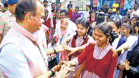 R&B Minister Komatireddy Venkat Reddy interacts with the students of Bottuguda High School in Nalgonda on Tuesday.
