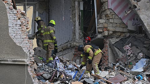 Rescue workers clear the rubble of a residential building which was heavily damaged after a Russian strike in Odesa, Ukraine, Tuesday, Jan. 27, 2026