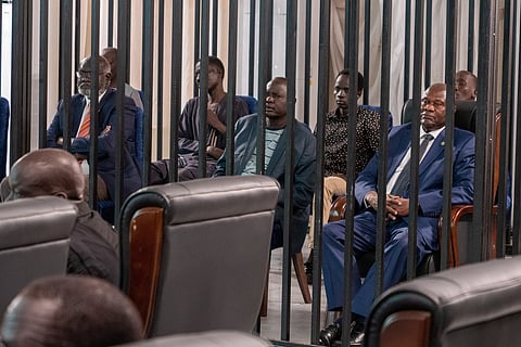 South Sudan's suspended First Vice President Riek Machar, seated at far right, is seen in the dock with seven others charged with murder, treason and crimes against humanity at the Freedom Hall in Juba, South Sudan, Sep. 24, 2025.