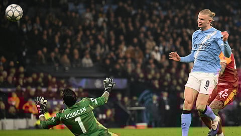Manchester City's Erling Haaland dinks the ball over Galatasaray’s keeper Ugurcan Cakır to open the scoring at the Etihad.