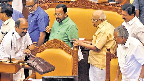 Chief Minister Pinarayi Vijayan and other ministers look on as Finance Minister K N Balagopal, carefully places the bag containing the budget speech on the desk at the Legislative Assembly Hall on Thursday