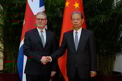 Britain's Prime Minister Keir Starmer, left shakes hands with National People's Congress Chairman Zhao Leji at the Great Hall of the People in Beijing, China, Thursday, Jan. 29, 2026.