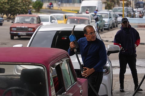 A driver refuels others wait in a long line behind to fill up at a gas station in Havana, Cuba, Tuesday, Jan. 27, 2026.