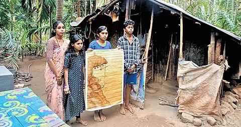 Wife of R Krishnan, who was awarded Padma Shri posthumously, and their children in front of their house in Kallar in Nilgiris.