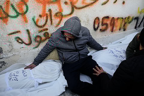 Mahmoud Al-Atbash mourns the bodies of his two daughters, Zeina and Maryam, who were killed in an Israeli military strike, at Shifa Hospital in Gaza City Saturday, Jan. 31, 2026.
