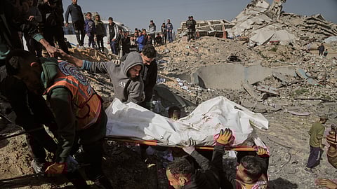 Palestinians carry a body from the rubble of police station after it was targeted by an Israeli army strike in Gaza City Saturday, Jan. 31, 2026