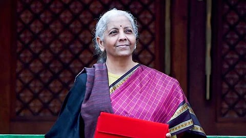 Finance Minister Nirmala Sitharaman with the digital tablet, enclosed in a traditional red 'bahi-khata' style pouch, at the Parliament premises before the presentation of the Union Budget 2026-27, in New Delhi, Sunday, Feb. 1, 2026.