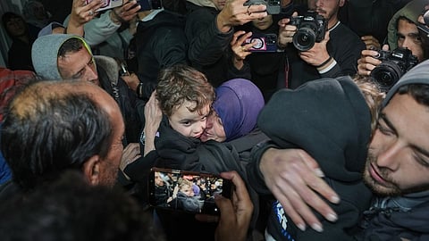 Najat Rubaie, center right, embraces one of her grandsons after they arrive with their mother as part of a group of about a dozen Palestinian returnees allowed into Gaza following the long-awaited reopening of the Rafah border crossing, at Nasser Hospital in Khan Younis, southern Gaza Strip, early Tuesday, Feb. 3, 2026.
