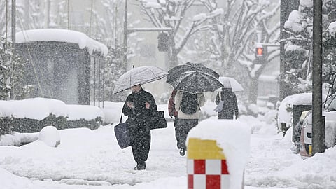 People walk in a snow in Kanazawa, Ishikawa prefecture, Japan, on Jan. 23, 2026.