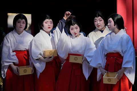 Local students dressed as shrine maidens participate in the annual Bean Throwing Festival in Hakone.