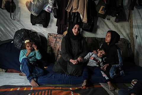 Rotana al-Regeb, who was allowed into Gaza from Egypt following the long-awaited reopening of the Rafah border crossing, reunites with her children in Khan Younis, southern Gaza Strip, Tuesday, Feb. 3, 2026.