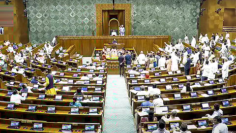 Opposition MPs seeking to gherao the Treasury benches in the Lok Sabha during the Budget session of Parliament in New Delhi on Wednesday.