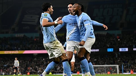 Manchester City's Omar Marmoush celebrates with Tijjani Reijnders (C) and Antoine Semenyo (R) after scoring the team's second goal during the English League Cup semi final second leg football match between Manchester City and Newcastle.
