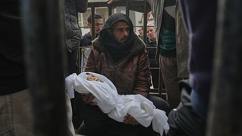 A relative holds the body of a few-months-old girl, Mira al-Khabbaz, after she was killed in an Israeli military strike, ahead of her burial at Shifa Hospital in Gaza City, Wednesday, Feb. 4, 2026.