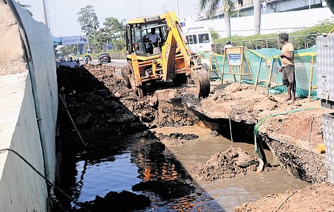 Metro water workers fixing road subsidence near the Roja Muthiah Research Library in Taramani on Wednesday.