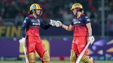 Royal Challengers Bengaluru's captain Smriti Mandhana, left, with teammate Georgia Voll during the Women's Premier League (WPL) 2026 final T20 cricket match between Delhi Capitals and Royal Challengers Bengaluru, at Baroda Cricket Association Stadium, Kotambi in Vadodara, Gujarat, Thursday, Feb. 5, 2026.