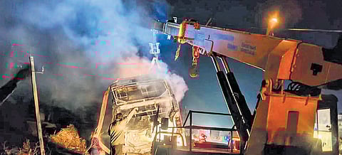 Smoke billows from a private bus after it catches fire, near Nelamangala, on the outskirts of Bengaluru on Friday.